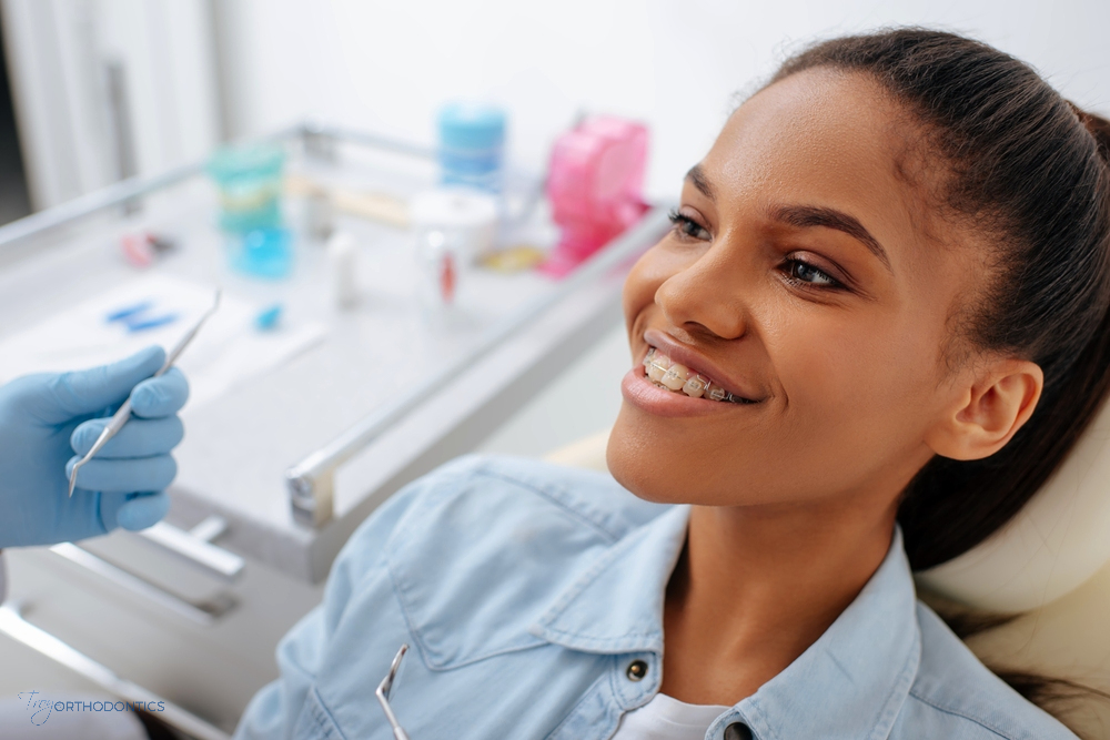 Smiling patient with clear braces, highlighting braces cost in little falls, nj